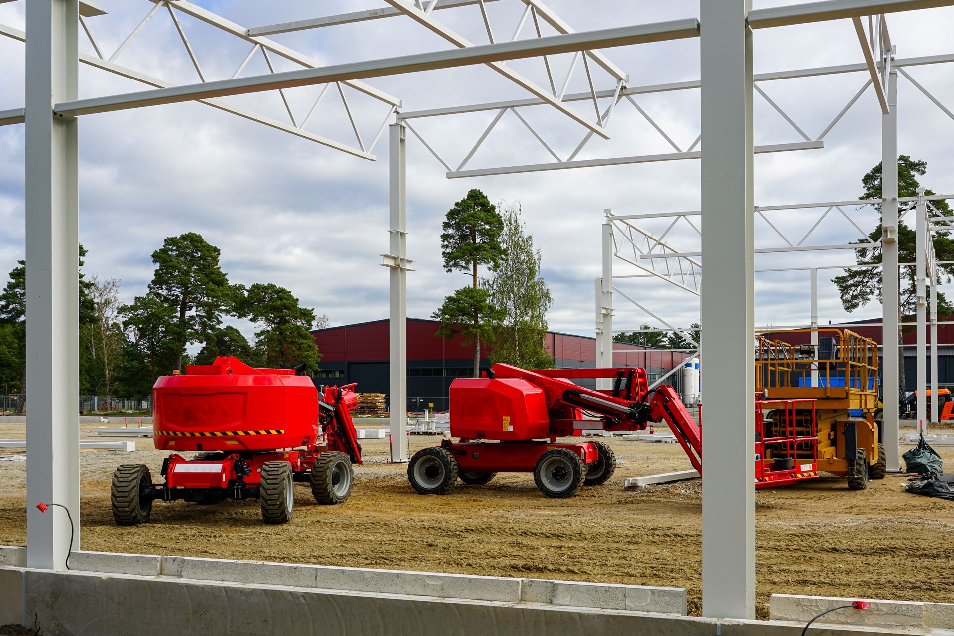 Modern self propelled construction hydraulic lifts on modern metal frame building construction site